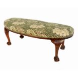 An Edwardian kidney shaped walnut stool, on short cabriole legs, with claw and ball feetCondition