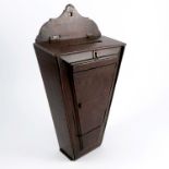 An Antique oak country house wall mounted letter box, of tapering triangular form, with slot to