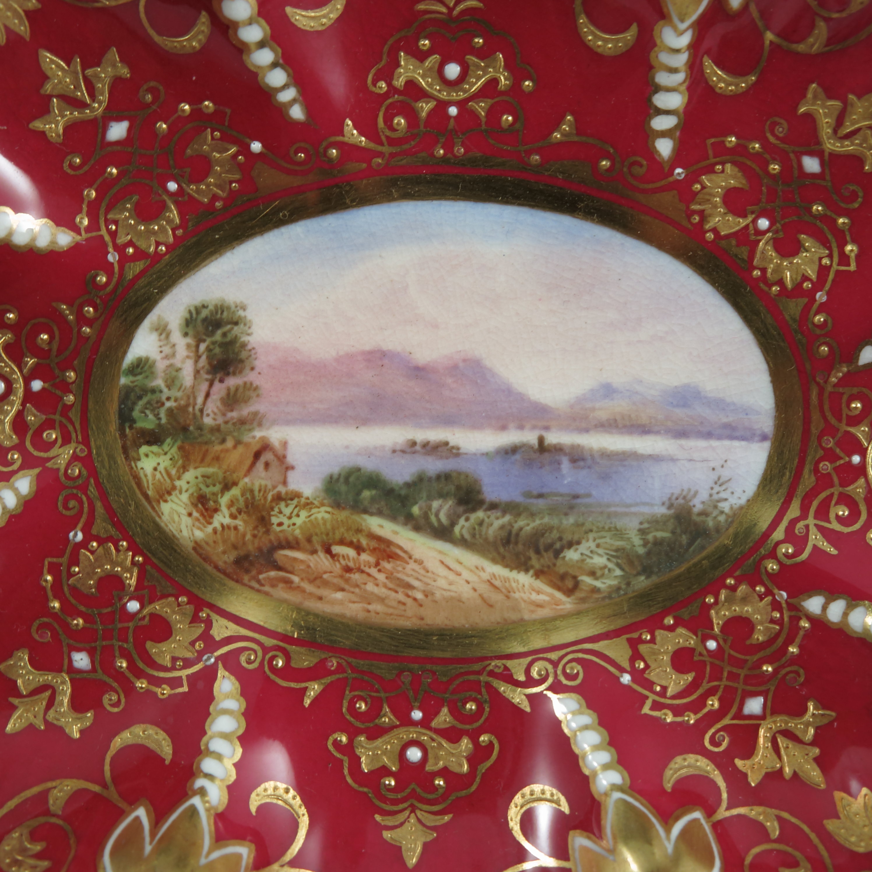 An oval Coalport dish, decorated with a central panel of a lake scene with buildings and - Image 3 of 3