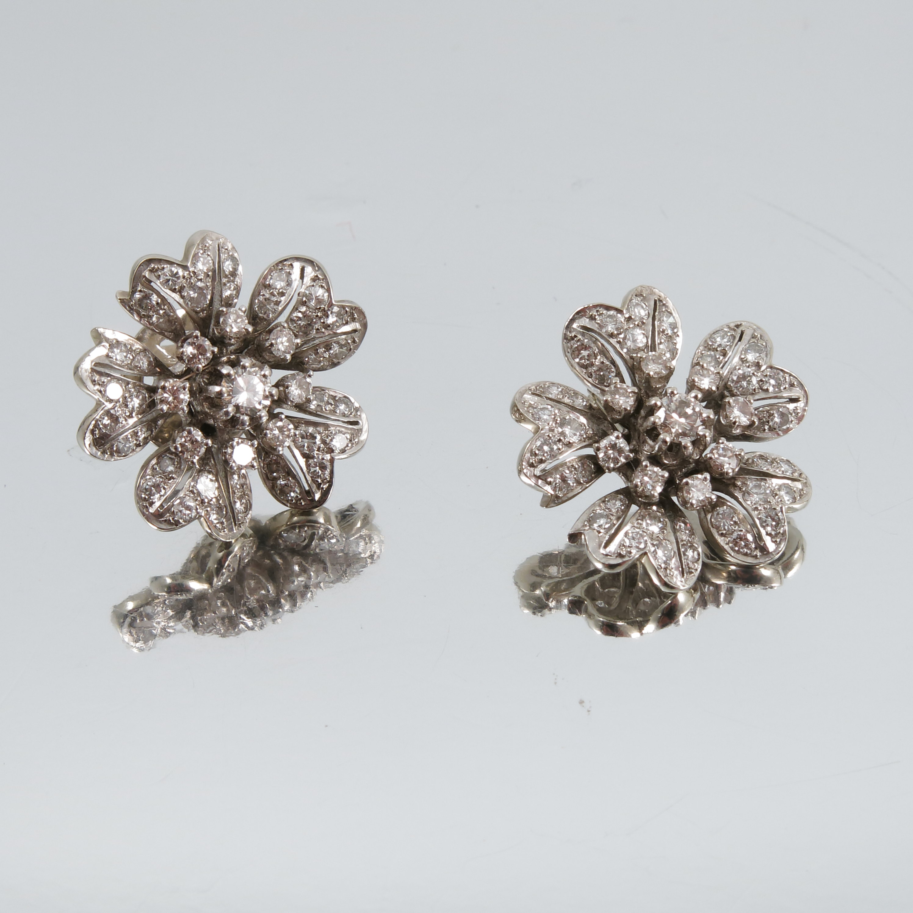 A pair of diamond flower head cluster ear studs, in unmarked white metal, the central diamond - Image 2 of 2