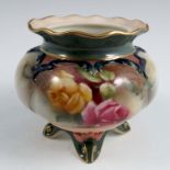 A Royal Worcester vase, decorated with roses on the Hadley's style, raised on four dolphin feet,