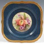 A Royal Worcester plate, decorated with a central panel of orchids by Albert Shuck, circa 1926, with