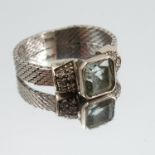 An aquamarine and diamond ring, the square cut  corner stone between single cut diamond set