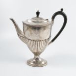 A silver coffee pot, with moulded edge, gadrooned lower body, raised on a pedestal with oval foot,