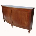 A 19th century mahogany bow front cupboard the doors opening to reveal shelves, raised on turned