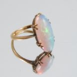 A single stone opal ring, stamped '18ct', finger size L 1/2, 2.6g gross, together with a single opal