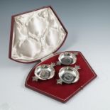 A cased set of three silver commemorative wine tasters, with crown handles, each set with a