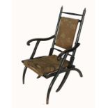 An Edwardian ebonised folding chair, with bamboo effect, upholstered seat and back panel