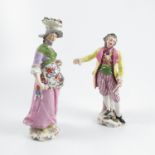 A pair of late 19th century continental porcelain figures, of a man wearing a yellow jacket and a