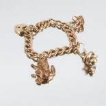 A 9 carat gold bracelet, of solid textured curb links, with three charms attached, 36g gross
