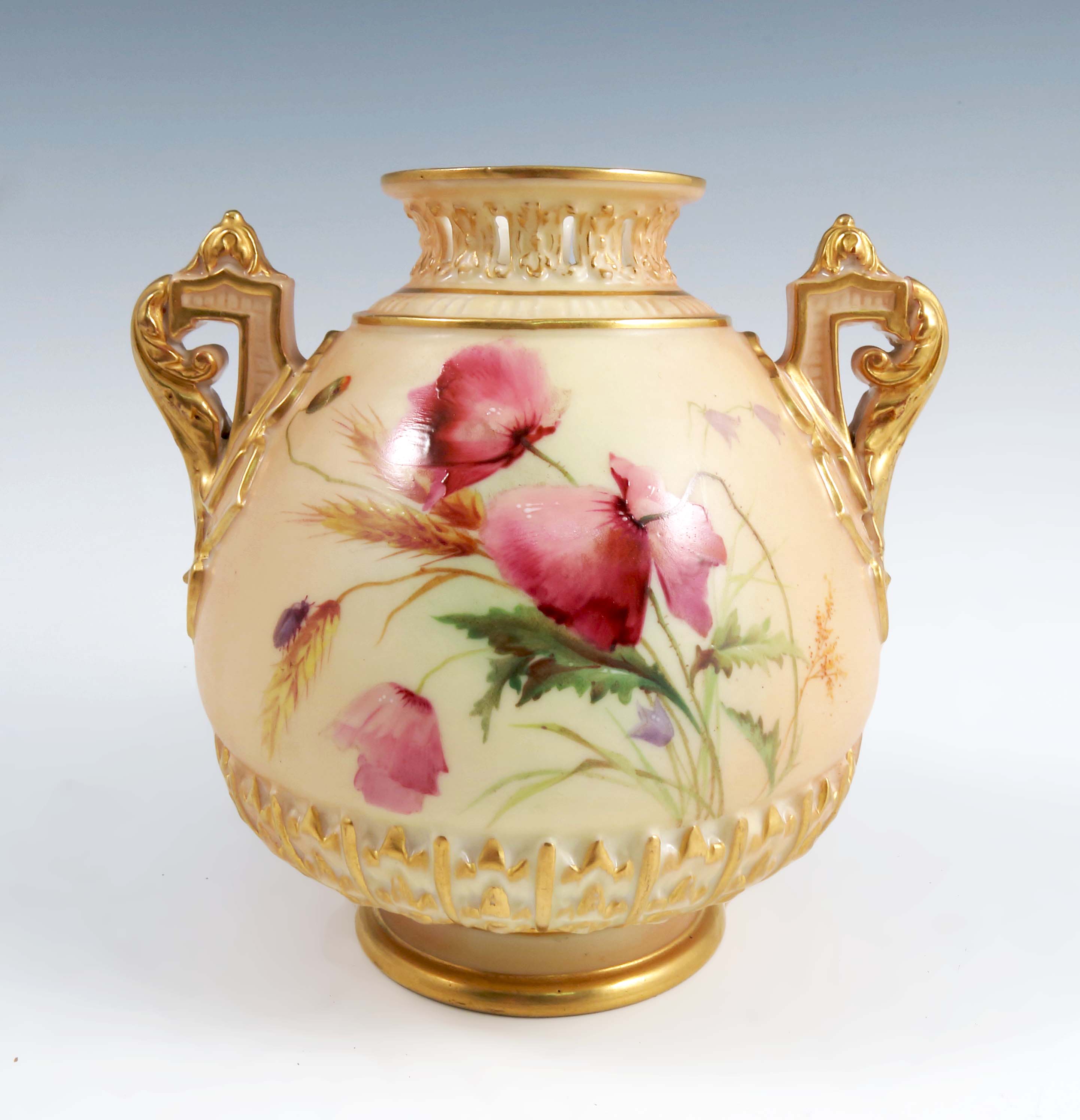 A Royal Worcester blush ivory two handled vase, decorated with poppies and insects, with pierced
