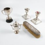 A collection of hallmarked silver, to include dwarf candlesticks, dressing table brush, napkin