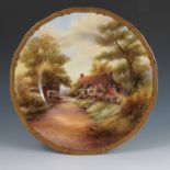 A Royal Worcester plate, fully decorated with a view of Wick with thatched buildings and figures, by
