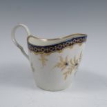 A 19th century Worcester milk jug, decorated in blue and gilt, crescent mark to base, height