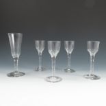 A set of four cordial glasses, with faceted lower bowl and stem, height 6ins, together with