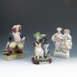 Five Staffordshire flat back figures, three modelled as couples, another of a man holding an