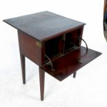An unusual mahogany worktable, having hinged drop leaf with lock, raised on four tapering legs,
