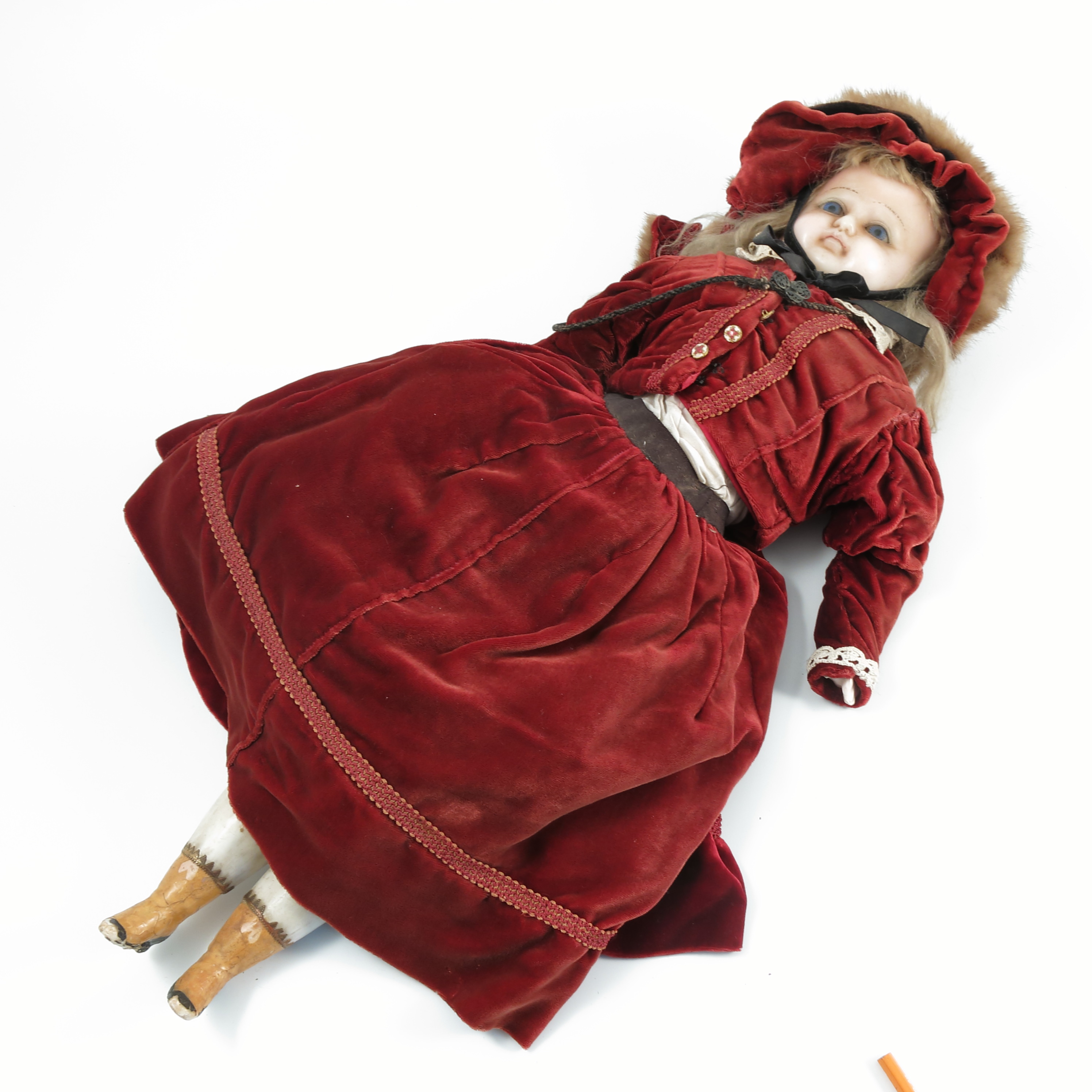 A 19th century wax doll, of a girl, the blue eyed girl dressed with 19th century style clothes of