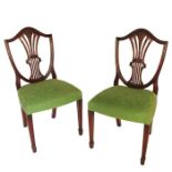 A set of eight Hepplewhite style shield back mahogany dining chairs