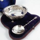 A cased Victorian silver bowl, of shaped circular form, with bead edge, the body embossed with