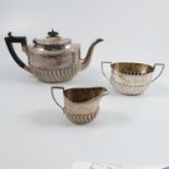 A silver three piece tea set, with wrythern gadrooned lower body, Sheffield 1896, weight 18oz all