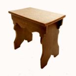 An antique oak stool, the rectangular top, raised on shaped end supports, 15.5ins x 10ins