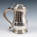 A Georgian silver lidded tankard, of waisted baluster form, with open thumb piece, scroll handle