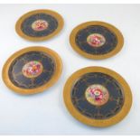 Four Royal Worcester cabinet plates, decorated with flowers by E Phillips, to a deep blue border