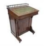 A Victorian rosewood Davenport, with gallery top over a rising lid, having cross banding, line and