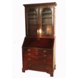 A 19th century mahogany bureau bookcase, having glazed top fitted with adjustable shelves over a