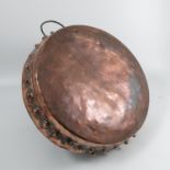 An antique Persian copper dish, with studded decoration to the sides