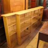 A pine break front bookcase, with fixed shelves, width 116ins, depth 12ins, height 41ins