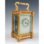 A gilt metal carriage clock, the striking movement with white enamel dial, decorated with floral