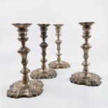 A set of four 18th century silver candlesticks, with knopped stems and shaped bases, the whole