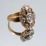 An eleven stone diamond cluster ring, stamped '18ct', the centre stone estimated as weighing