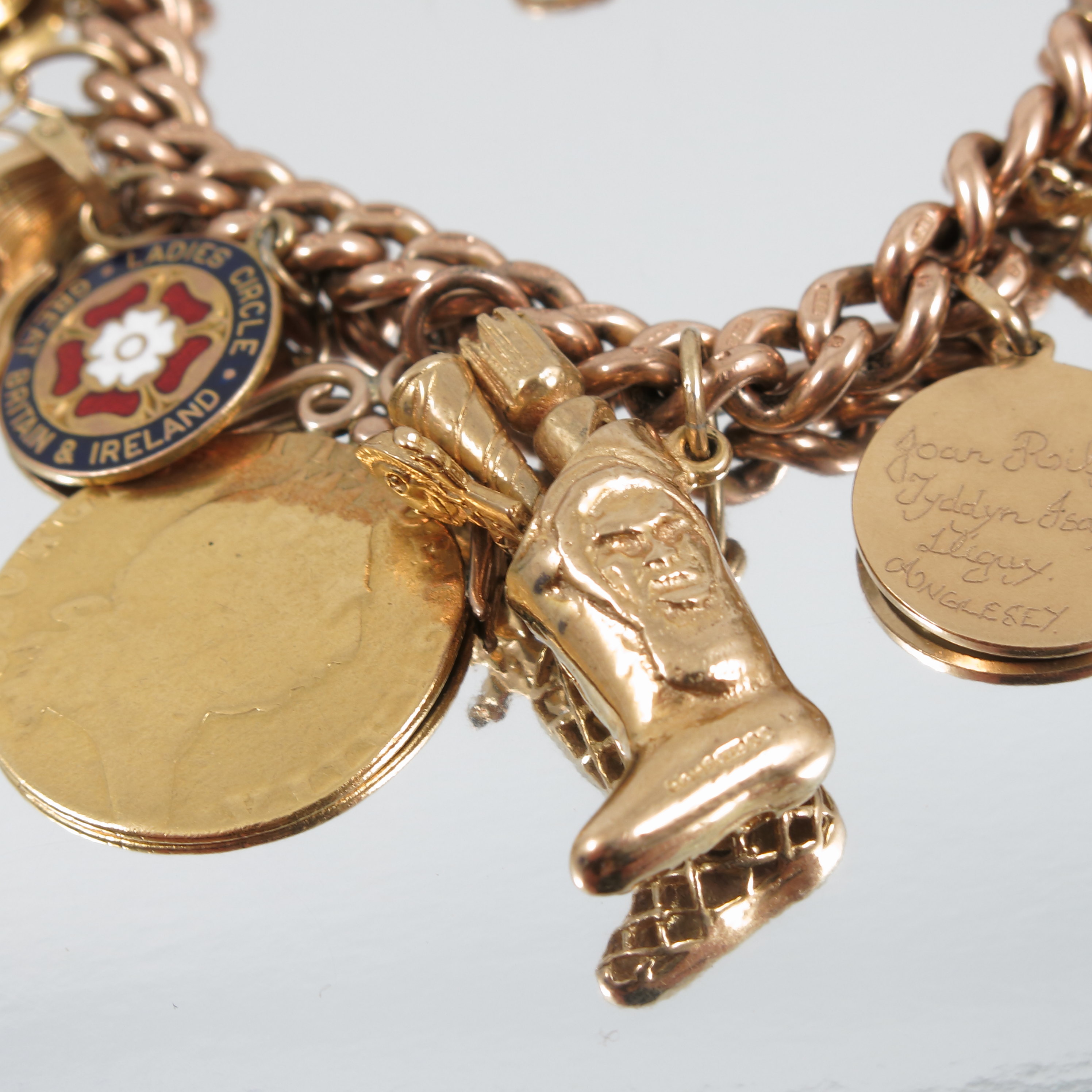 A 9 carat gold bracelet, of solid curb links, with sixteen charms attached including a Spade Guinea, - Image 2 of 4