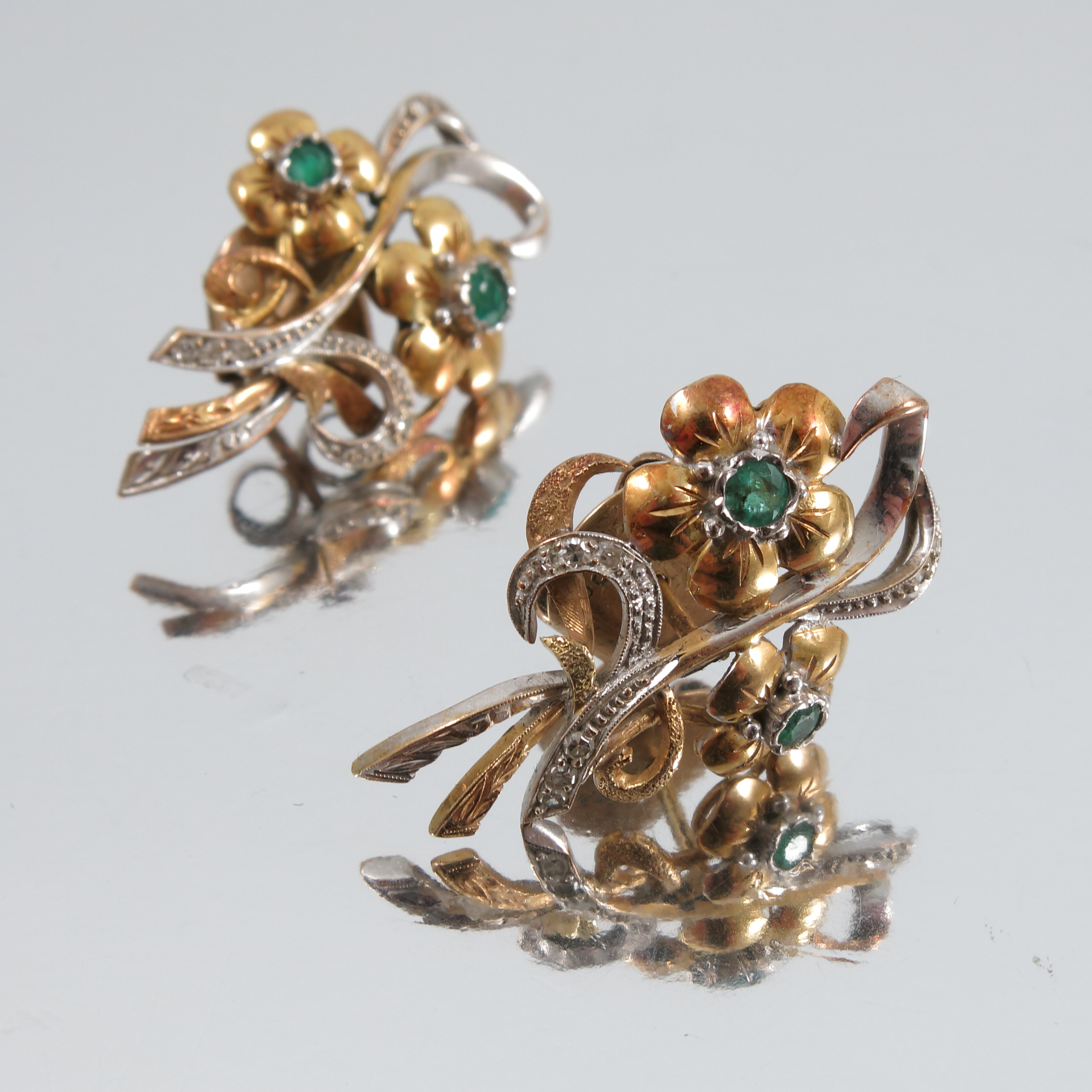 A pair of emerald and single cut diamond spray earstuds, the two flower heads set with emeralds, and