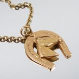 A horseshoe enclosing a horse's head pendant, stamped '750', 4g gross, on a chain, stamped '585',