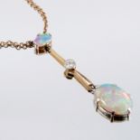 An opal and diamond drop pendant, circa 1920, the oval cabochon measuring approximately 7.1mm