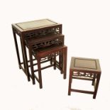 A nest of four Oriental hardwood tables, with pierced borders, 20ins x 14ins