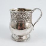 A Georgian silver mug, the body with embossed band of decoration, engraved with initials, with