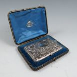 A cased silver aide memoir, of hinged rectangular form, heavily decorated with scrolls and