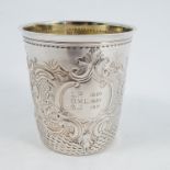A 19th century French silver tumbler cup, with gilt wash interior, embossed with scrolls and flowers