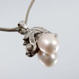 A freshwater cultured pearl and diamond pendant, the bale stamped 14k, the pearl approximately