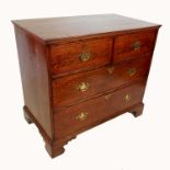 An antique oak chest of drawers, having two short drawers over three long drawers, raised on bracket