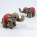 Two Steiff elephants, with red cloths on their backs