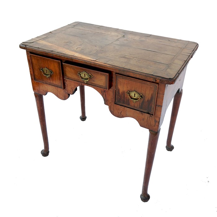 An 18th century walnut lowboy, having a quarter veneer cross banded top, fitted with three - Image 2 of 2