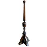 An antique style standard lamp, with baluster carved column, raised on four splayed supports