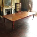 A Victorian mahogany extending dining table, fitted with three leaves, raised on carved and reeded