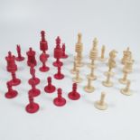 A 19th century turned bone chess set, in white and stained red, thirty-two pieces, height of king